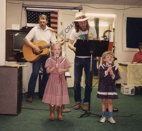 Erin and Amber singing with their father and his friend Larry Bowman at the Cuba Rock-A-Thon circa 1992.