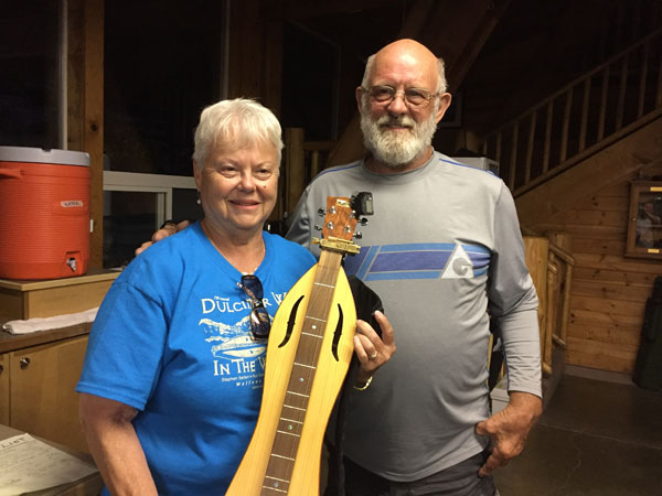 Leanna and Les McMasters with the dulcimer he built.