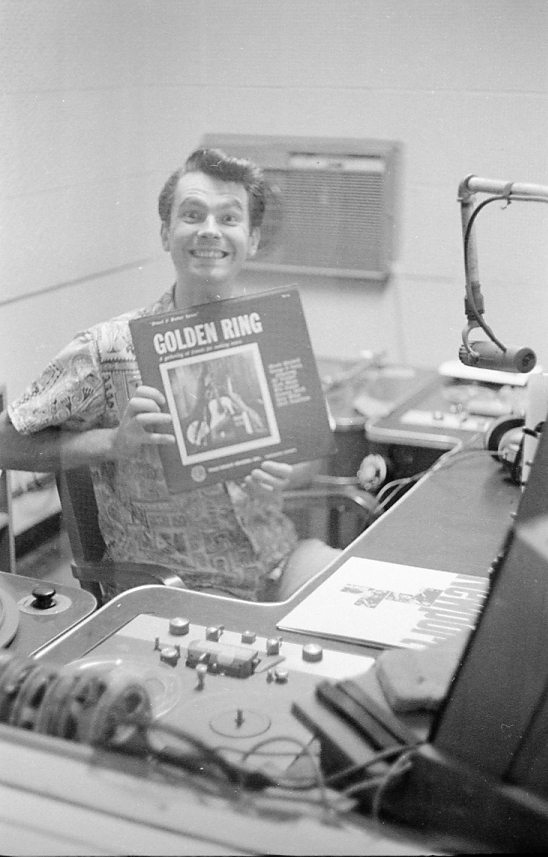 Radio station DJ John Dildine holding the Golden Ring album. (1960s)